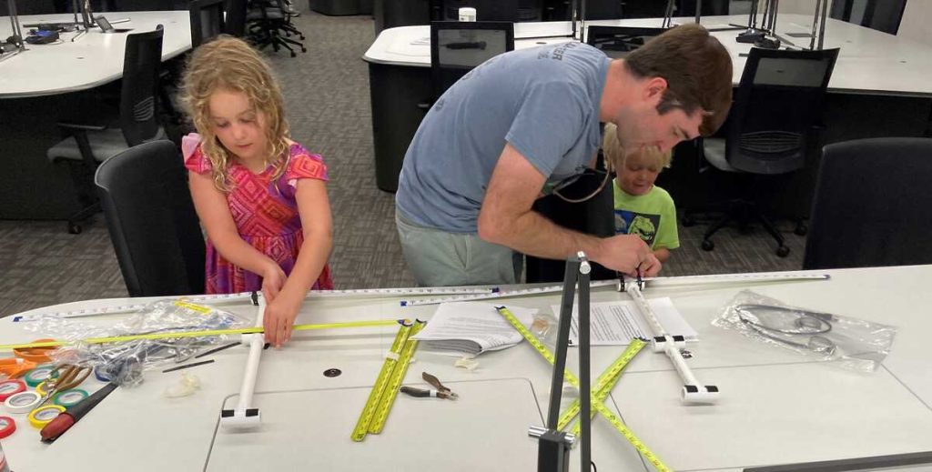 Andrew, N5EI and his children building tape measure Yagis [Dave, KI4PSR]
